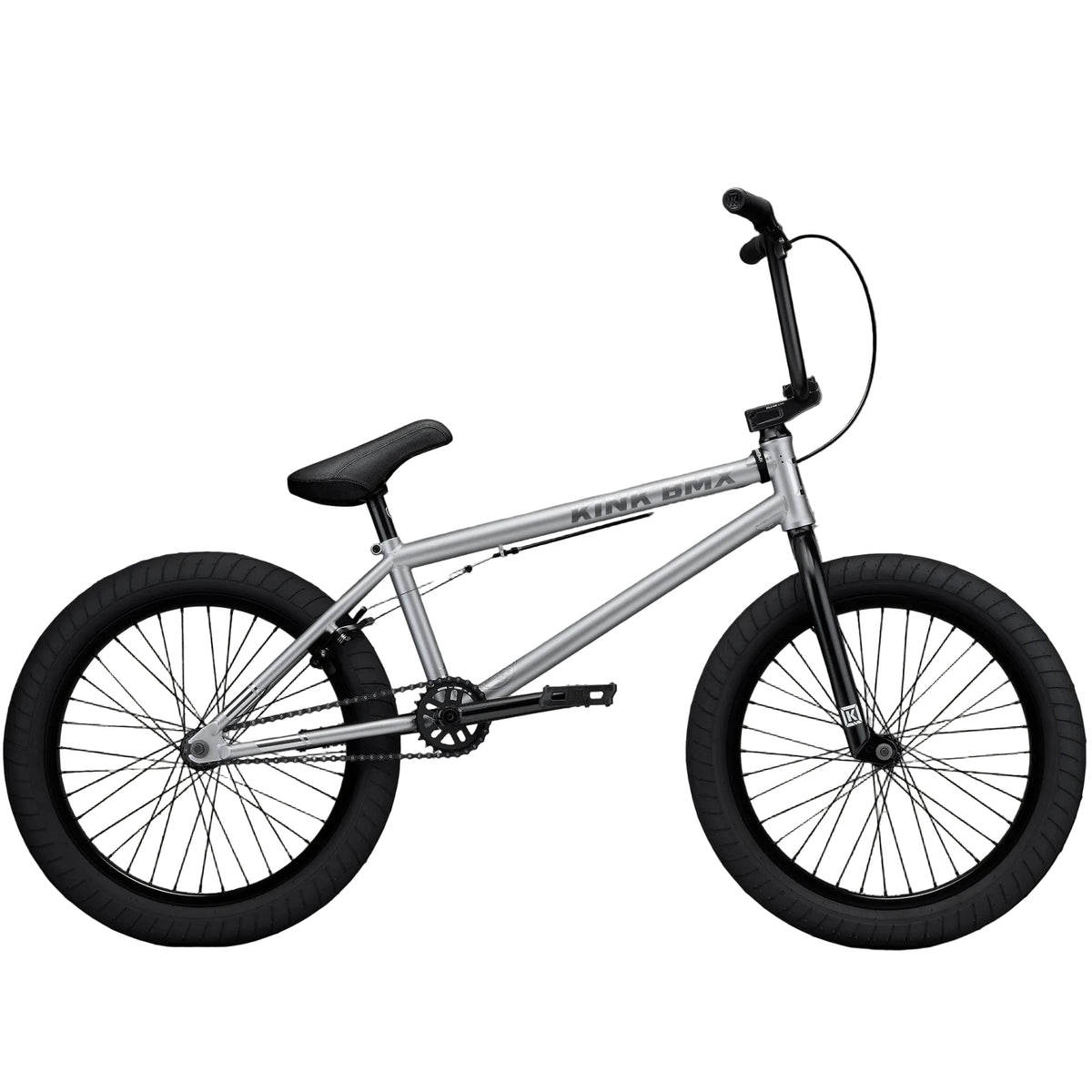 White BMX bike with black tires against a gray concrete wall