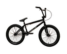 A black Sunday BMX bike with knobby tires and a step-through frame, positioned in front of a yellow-brown paneled wall with the brand name 'Sunday' printed on it.