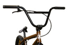 Close-up of a BMX bike handlebars and frame, featuring black handlebars with black grips, a brown frame, and a white stylized 'S' logo on the down tube, set against a background of yellow cardboard boxes with 'Sunday' printed on them.